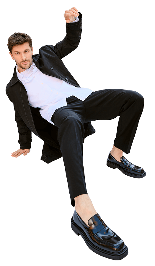Male model posing with one hand on the ground and the other hand in the air at 720 West End Avenue