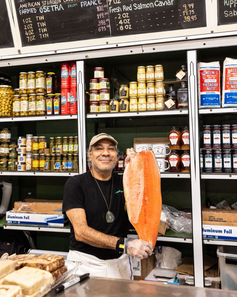 Local fishmonger showing off a freshly cut salmon, Upper West Side Manhattan