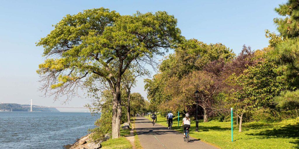 People riding bikes by Riverside Park near 720 West End Avenue