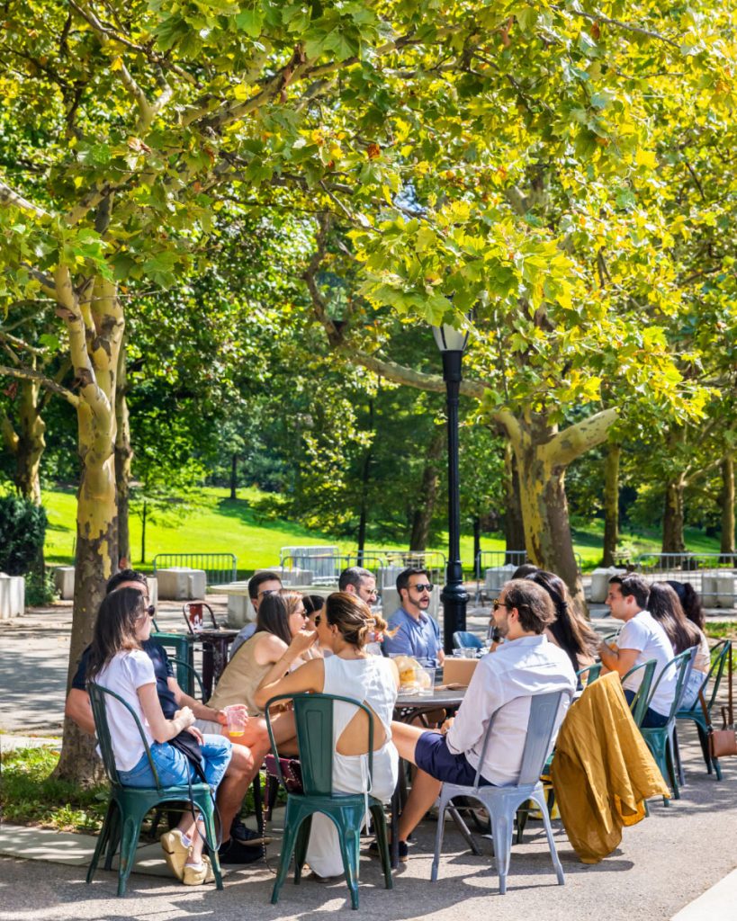 A group of people dining in Riverside Park near 720 West End Avenue